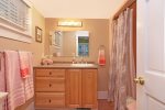 Main level primary ensuite bathroom with shower tub combo